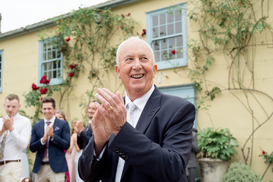wedding guest clapping after confetti
