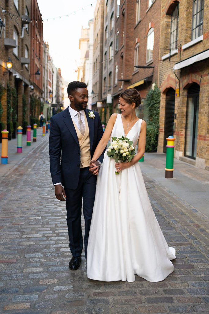 documentary wedding photographer in London captures bride and groom in Covent Garden