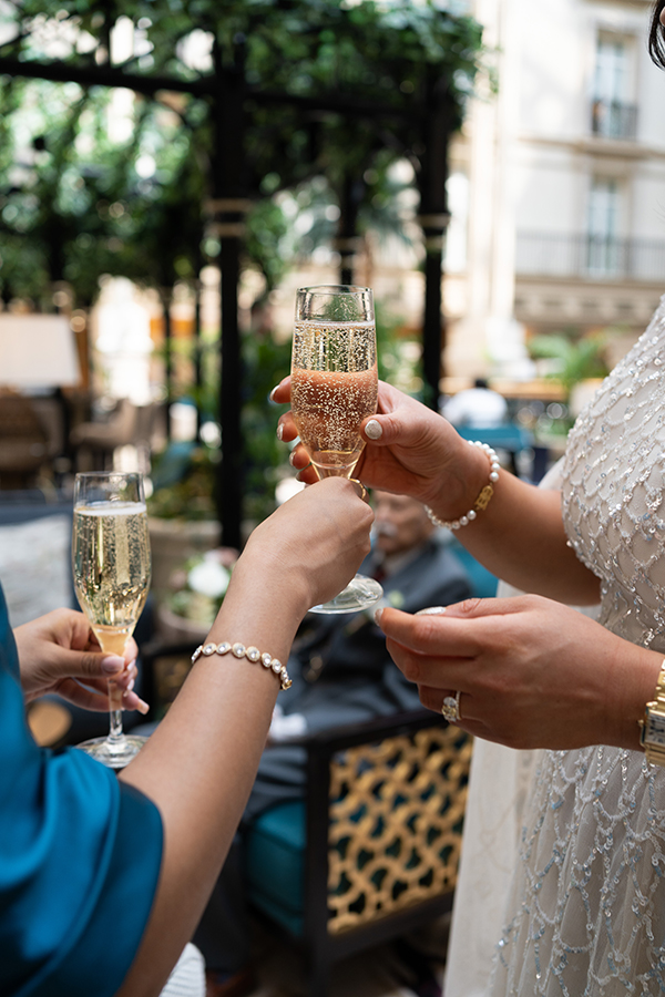 close up shot of Landmark Hotel staff hands bride champagne